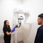 assistant with patient taking xrays at Lumi Dentistry