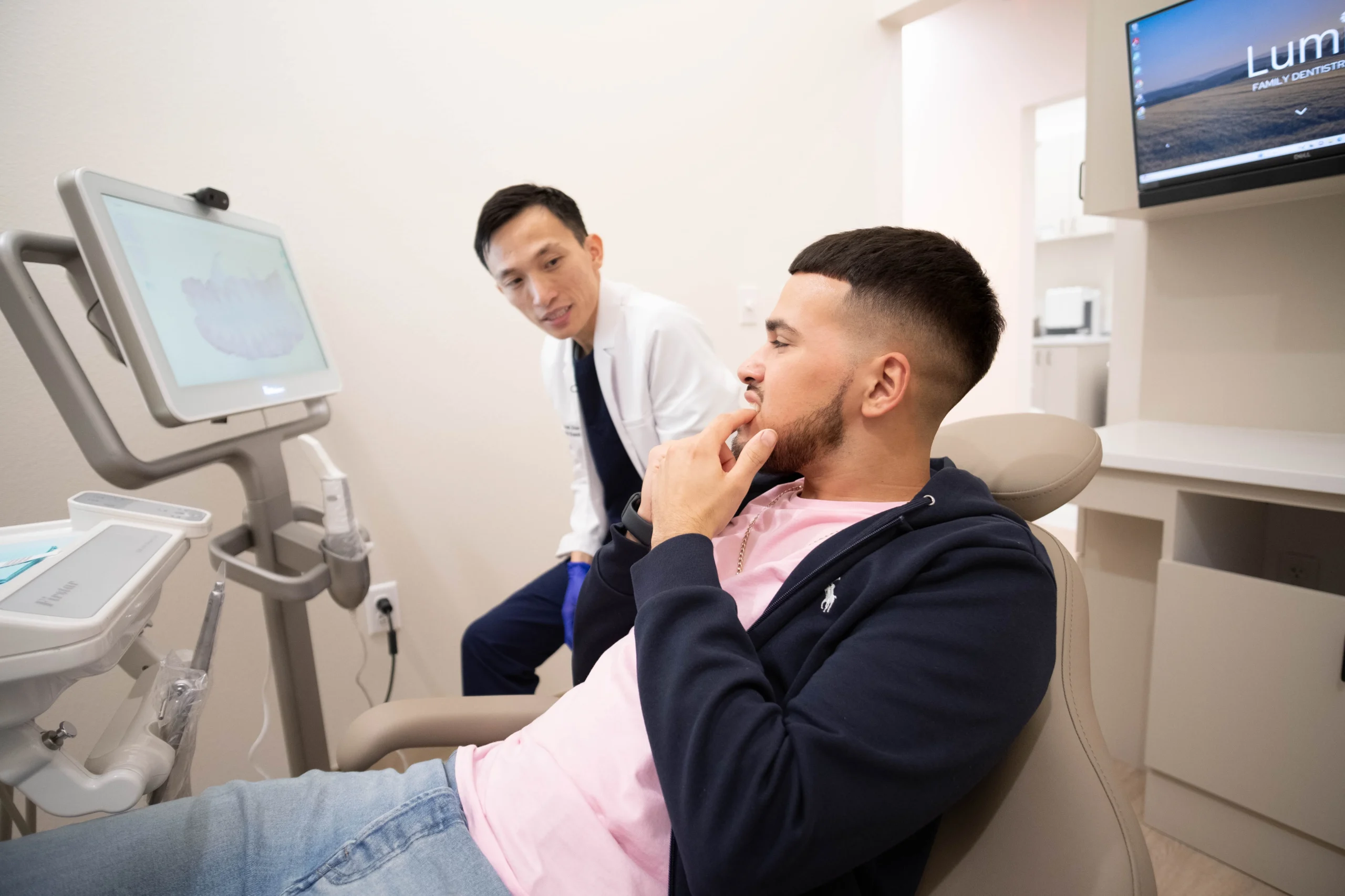 Lumi Dentistry Dr. Hao Dang, DMD discussing options with younger male patient