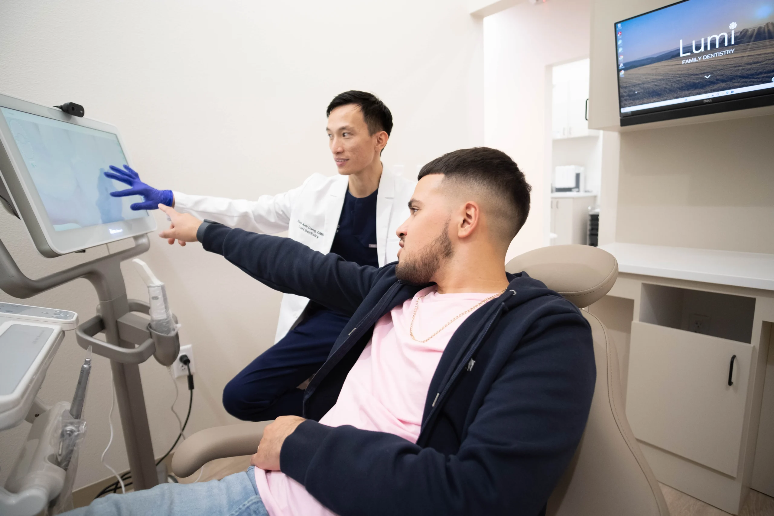 Lumi Dentistry Dr. Hao Dang, DMD reviewing scan with younger male patient